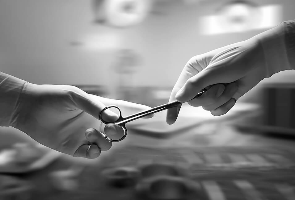 surgeons passing surgical scissors